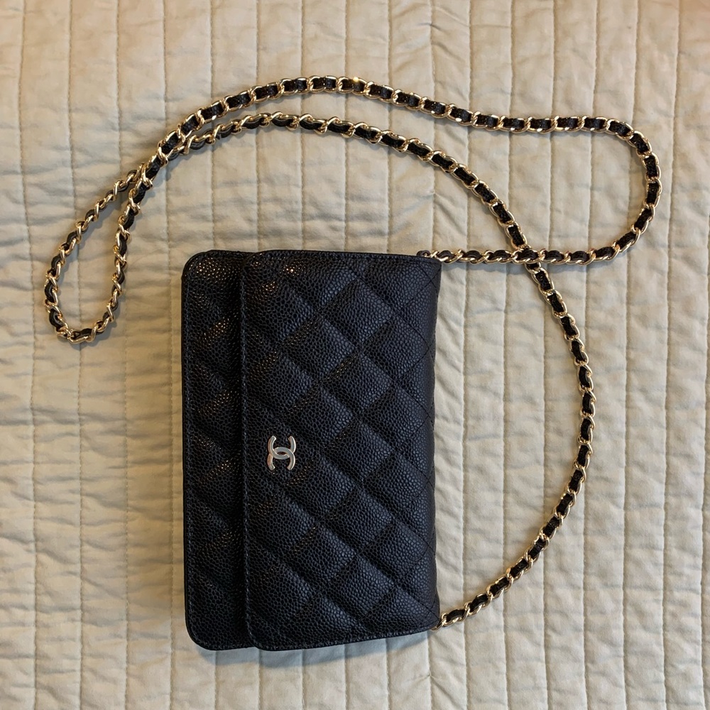 Black quilted crossbody bag, wallet on a chain.